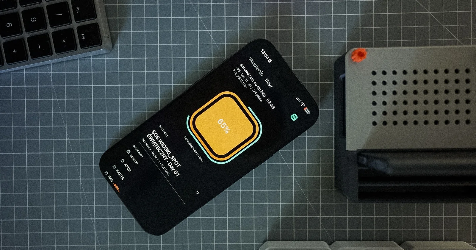 iPhone with Habitat Flow lying on the desk next to a dock, showing an ingest