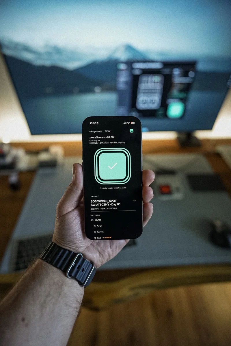 iPhone in hand with the "verified" screen, Mac behind